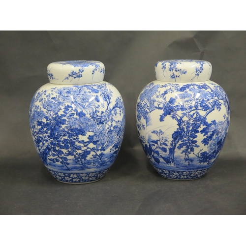 612 - A Large Pair of Chinese Qing Porcelain Blue and White Jars with stoppers and covers decorated with c... 