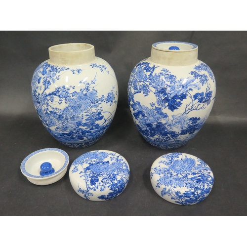 612 - A Large Pair of Chinese Qing Porcelain Blue and White Jars with stoppers and covers decorated with c... 