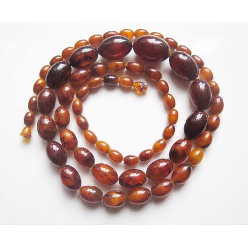 1916 - A Faux Amber Graduated Bead Necklace, 108cm, largest bead 30x20mm, 85.2g