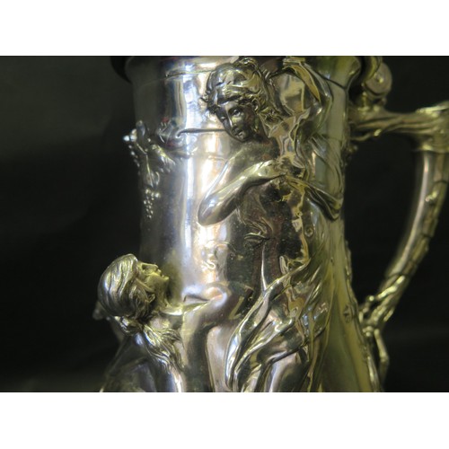 1245 - A Large Silver Plated Silver Plated Flagon with high relief decoration of Pan , three graces and put... 