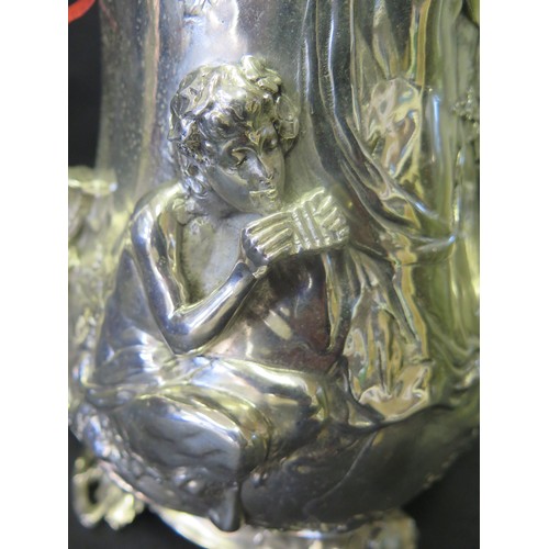 1245 - A Large Silver Plated Silver Plated Flagon with high relief decoration of Pan , three graces and put... 