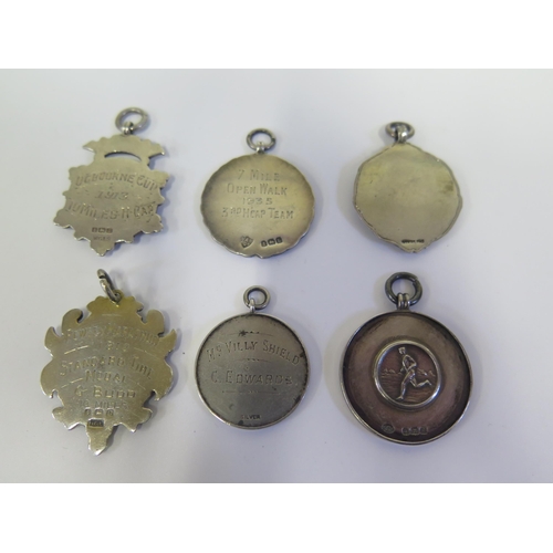 111 - A Collection of Six Silver Running Medallions including Highgate Harriers 1935, Pewsey Marathon 1912... 