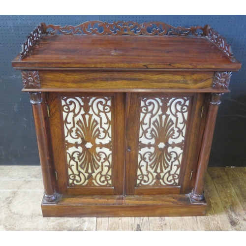 1886 - A Victorian Rosewood Cupboard with three quarter galleried top decorated with foliate scroll fretwor... 