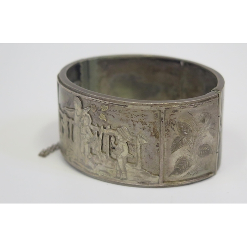 203 - An Unmarked 19th century Silver Hinged Bangle with relief decoration of a woman with children workin... 