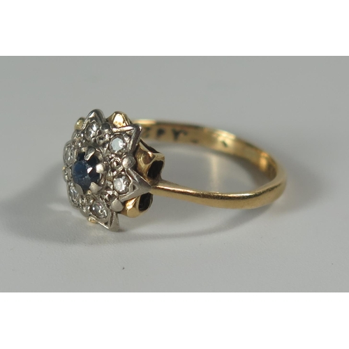 275 - An 18ct Gold, Sapphire and Diamond Cluster Ring, 11mm head, size K.5, 3g