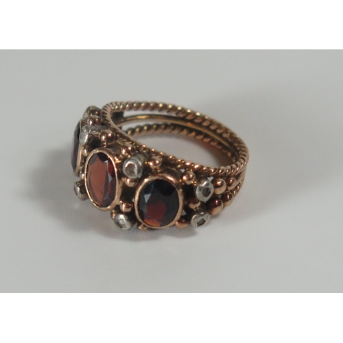 290 - A Garnet and Rose Cut Diamond Ring in a rub over unmarked gold setting, 23x11mm head, size K, 7.1g