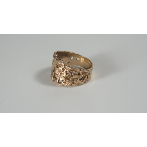 296 - A 9ct Gold Ring with pierced and chased floral foliate decoration, 13mm wide, size O, 5.1g