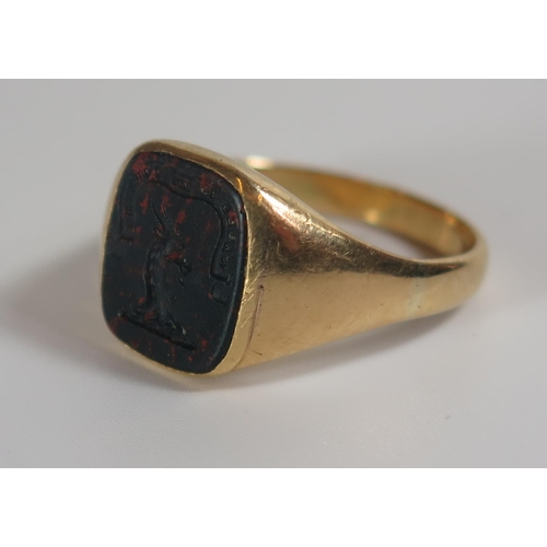 332 - An 18ct Gold and Bloodstone Seal Ring engraved with a goats head and 'WALES IS MY COUNTRY', size Q.5... 