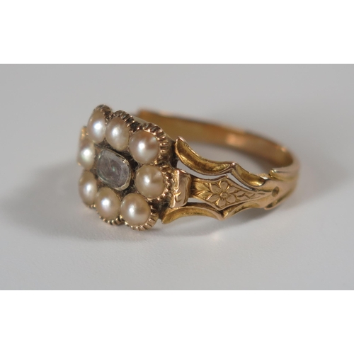 357 - A Georgian Pearl and Hair Memorial ring with chased flower head shoulders and in an unmarked gold se... 