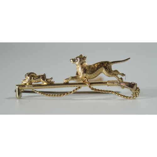 362 - A Cased 15ct Gold Bar Brooch in the form of a whip with a dog chasing a hare, rose cut diamond eye t... 