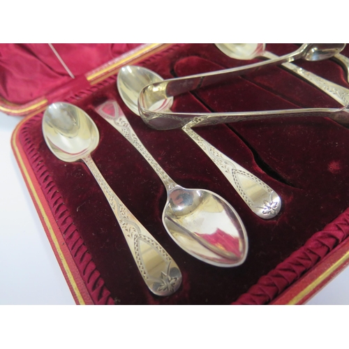 66 - A Cased Set of Six Victorian Silver Teaspoons and sugar tongs with bright cut decoration, Sheffield ... 