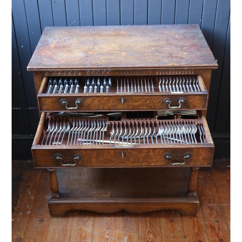 100 - An Elkington & Co. Oak Canteen Table for Twelve, largely complete and with additional cutlery includ... 