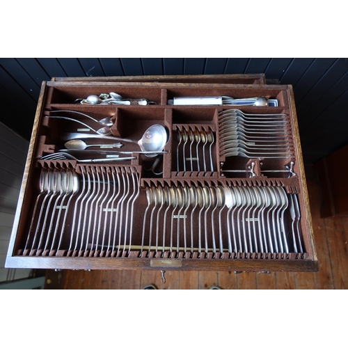 100 - An Elkington & Co. Oak Canteen Table for Twelve, largely complete and with additional cutlery includ... 