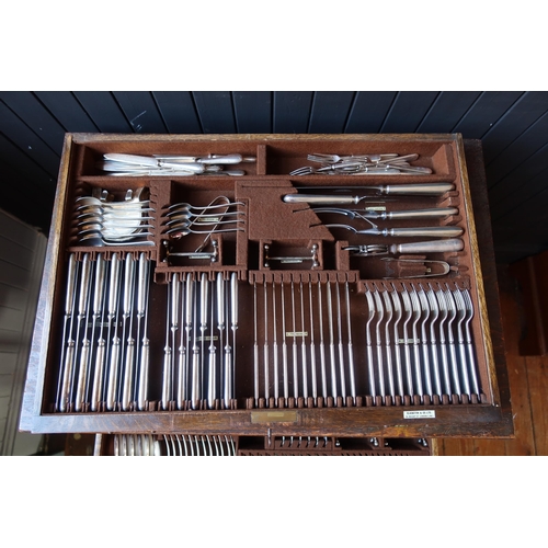 100 - An Elkington & Co. Oak Canteen Table for Twelve, largely complete and with additional cutlery includ... 