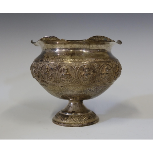 105 - An Indian Silver Stemmed Bowl with ebossed Hindu figures, 13 cm diam. x 11.5 cm high, 213.3 g