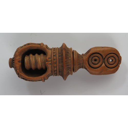 146 - A 19th Century Continental Treen Nutcracker with profuse carved decoration, 10 cm