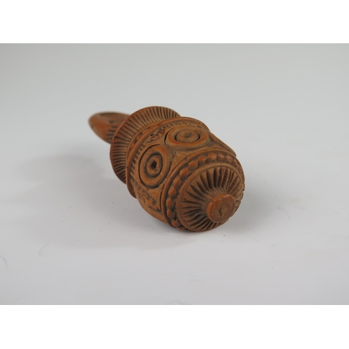 146 - A 19th Century Continental Treen Nutcracker with profuse carved decoration, 10 cm