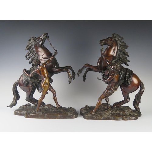 247 - A Pair of French Bronze Marly Horses, bases signed Coustou, 45 cm high, bases 33.5 cm