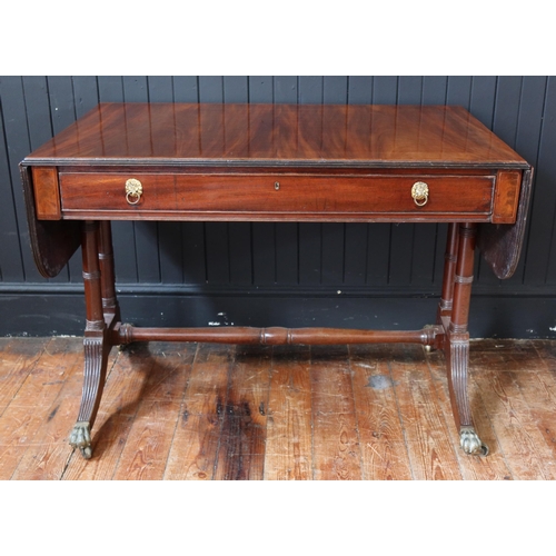 258 - An Early C19th Regency Mahogany and Tulipwood Crossbanded Sofa Table with a frieze drawer, on brass ... 