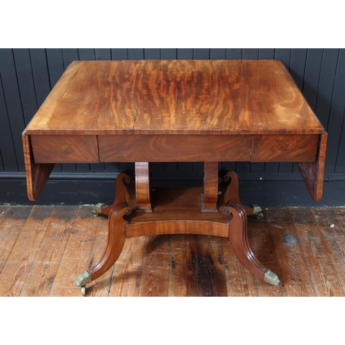 259 - An Early 19th Century Mahogany Drop Leaf Sofa Table raised on twin lyre shaped supports with quadrup... 