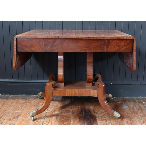 259 - An Early 19th Century Mahogany Drop Leaf Sofa Table raised on twin lyre shaped supports with quadrup... 