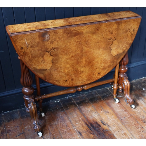 260 - A Victorian Burr Walnut Sutherland Table raised on turned and reeded columns with white porcelain ca... 