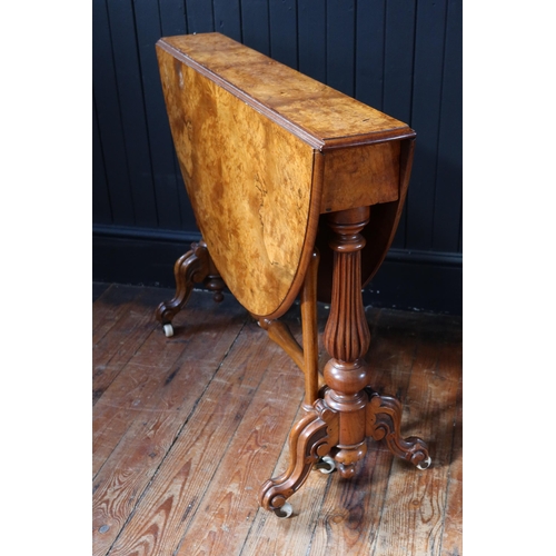 260 - A Victorian Burr Walnut Sutherland Table raised on turned and reeded columns with white porcelain ca... 