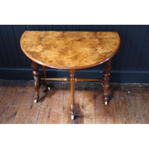 260 - A Victorian Burr Walnut Sutherland Table raised on turned and reeded columns with white porcelain ca... 