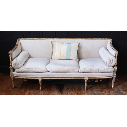 263 - A George III White Painted & Parcel-Gilt Sofa, Late 18th Century with a Reeded & Chanelled Toprail.
... 