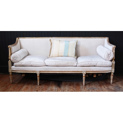 263 - A George III White Painted & Parcel-Gilt Sofa, Late 18th Century with a Reeded & Chanelled Toprail.
... 