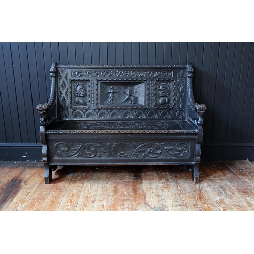 269 - A 19th Century Heavily Carved and Stained Oak Seat with lift up seat decorated with a central scene ... 