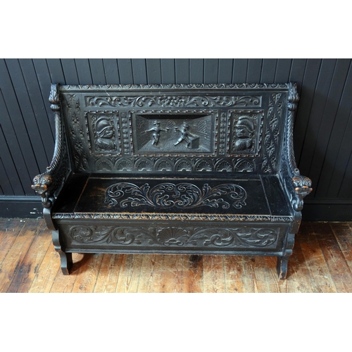 269 - A 19th Century Heavily Carved and Stained Oak Seat with lift up seat decorated with a central scene ... 