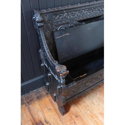 269 - A 19th Century Heavily Carved and Stained Oak Seat with lift up seat decorated with a central scene ... 