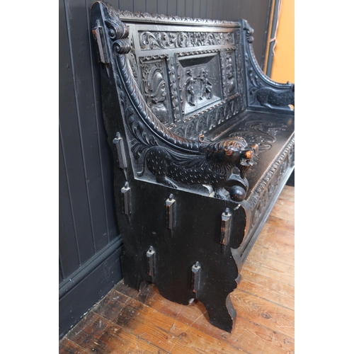 269 - A 19th Century Heavily Carved and Stained Oak Seat with lift up seat decorated with a central scene ... 