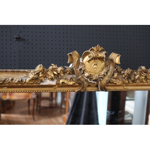 272 - A Late 19th Century French Gilt Composition Overmantle Mirror with a floral cartouche cresting above... 