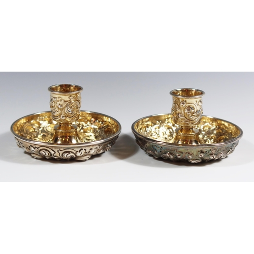 28 - A Sterling Silver Twin Candlestick Travelling Set with embossed foliate scroll decoration and gilt l... 