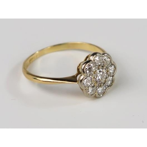 301C - An 18ct Yellow Gold and Diamond Nine Stone Flower Head Cluster Ring, 10.5mm diam. head, size M, 2.3g... 