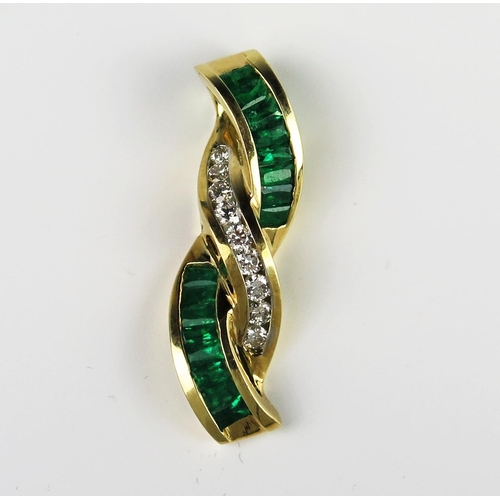 304A - A Baguette Cut Emerald and Round Cut Diamond Pendant in an unmarked gold setting, 35 mm drop, 6.9g

... 