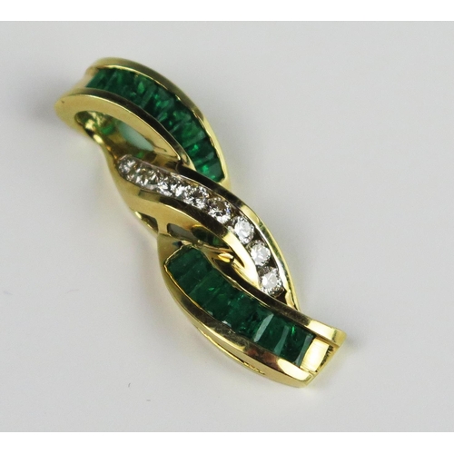 304A - A Baguette Cut Emerald and Round Cut Diamond Pendant in an unmarked gold setting, 35 mm drop, 6.9g

... 