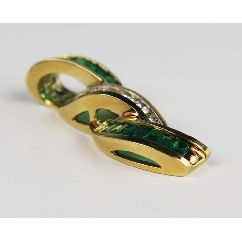 304A - A Baguette Cut Emerald and Round Cut Diamond Pendant in an unmarked gold setting, 35 mm drop, 6.9g

... 