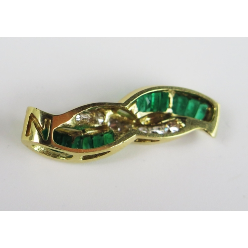 304A - A Baguette Cut Emerald and Round Cut Diamond Pendant in an unmarked gold setting, 35 mm drop, 6.9g

... 