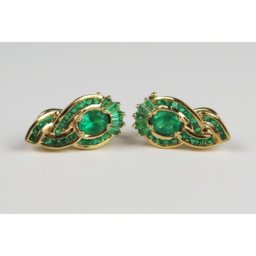 304C - A Pair of Emerald Stud Clip Back Earrings with oval, baguette and round cuts in an unmarked gold set... 