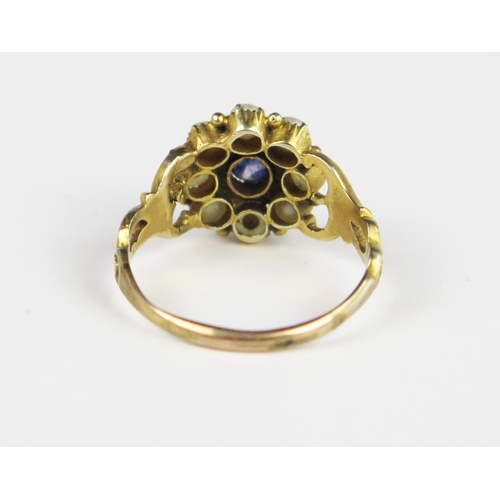 312A - A Good Georgian Amethyst and Pearl Cluster Ring in an unmarked gold setting with pierced foliate sho... 