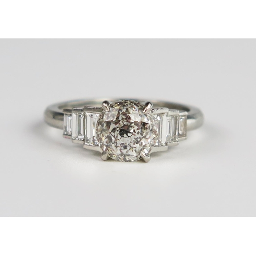337 - A Hans D. Krieger Diamond Ring in a .950 Platinum Setting, the central round novelty cut stone flank... 