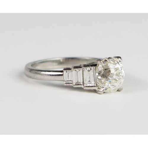 337 - A Hans D. Krieger Diamond Ring in a .950 Platinum Setting, the central round novelty cut stone flank... 