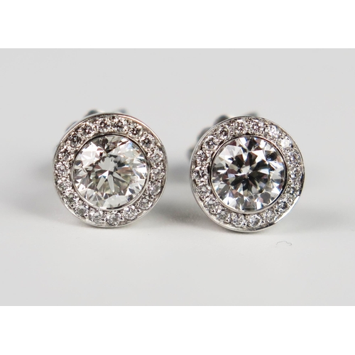 338 - A Pair of Hans D. Krieger 18ct White Gold Diamond Stud Earrings, the central brilliant round cut sto... 