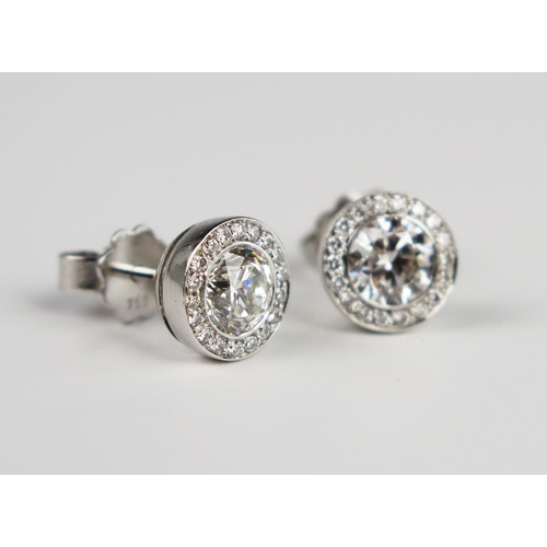 338 - A Pair of Hans D. Krieger 18ct White Gold Diamond Stud Earrings, the central brilliant round cut sto... 