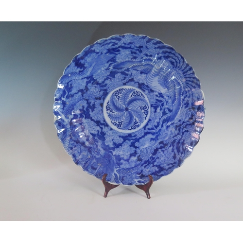 340A - A Japanese Meiji Period Blue and White Porcelain Charger with lobed edges and decorated with a drago... 