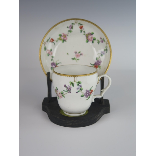 392 - An 18th Century Bristol Porcelain Cup and Saucer with floral swag decoration, underglaze marks to ba... 