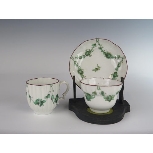 397 - An 18th Century Bristol Porcelain Tea Bowl with Saucer and a coffee can with green foliate swag deco... 